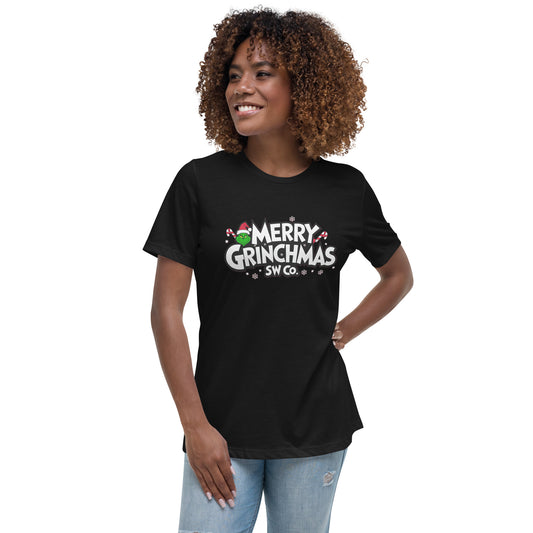 Woman wearing black Merry Grinchmas graphic t-shirt with Santa hat and candy canes, casual jeans